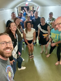 a group of people taking a selfie in a tunnel